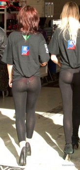 a car show girl tied her shirt up to show off her see-through ass