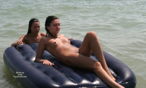 Two gals using an inflatable raft/boat for fun in the sun
