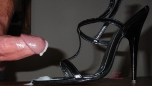 A man ejaculating into her empty shoe