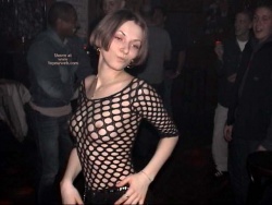 Wearing a mesh top to the delight of fellow clubbers