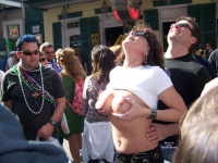Wearing Street clothes at Mardi Gras and holding her tits